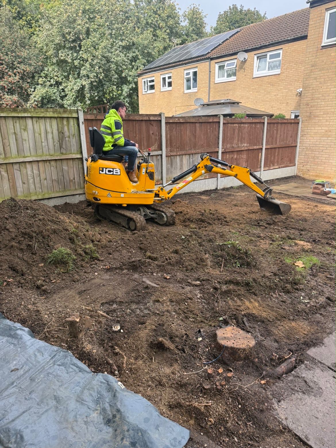 Sterling Plant Group JCB 8008 CTS micro digger working in a residential rear garden